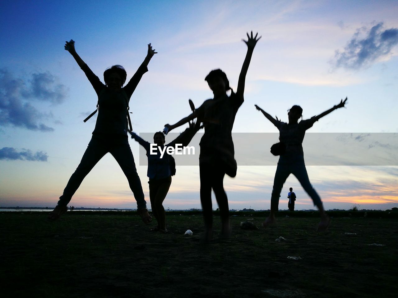 People on field against sky during sunset sihoutte