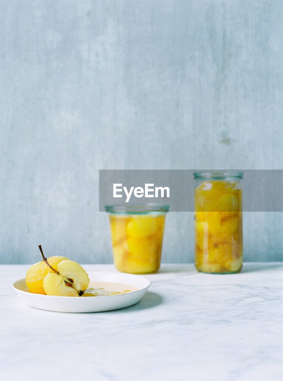 CLOSE-UP OF DRINK WITH JUICE ON TABLE