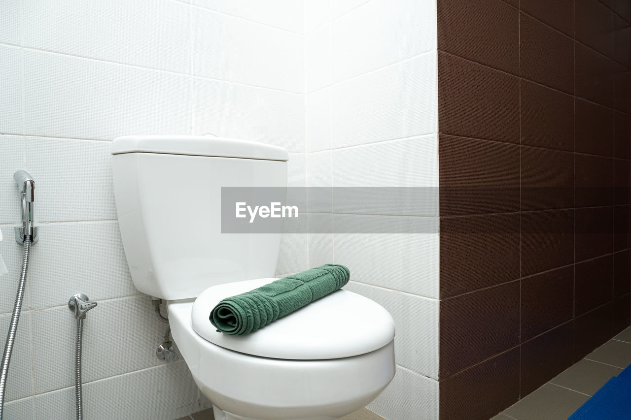 toilet, bathroom, room, bidet, tile, domestic bathroom, flooring, plumbing fixture, hygiene, domestic room, home, indoors, floor, toilet seat, restroom, public building, no people, toilet bowl, tiled floor, urinal, public restroom, white, wall - building feature, toilet paper, clean