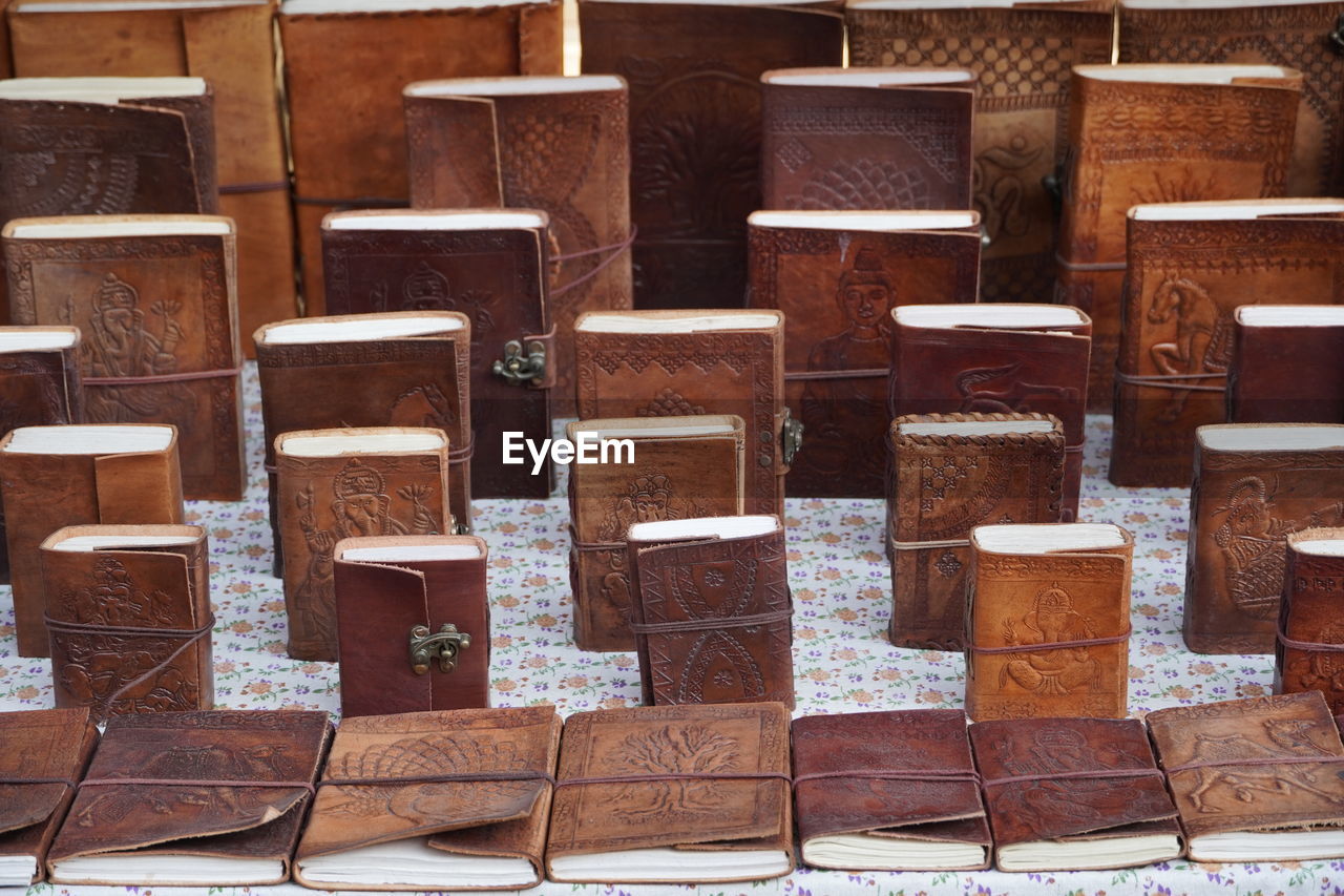 Handmade leather notebook, books and agendas outside at a shop for sale. souvenir shop handmade.