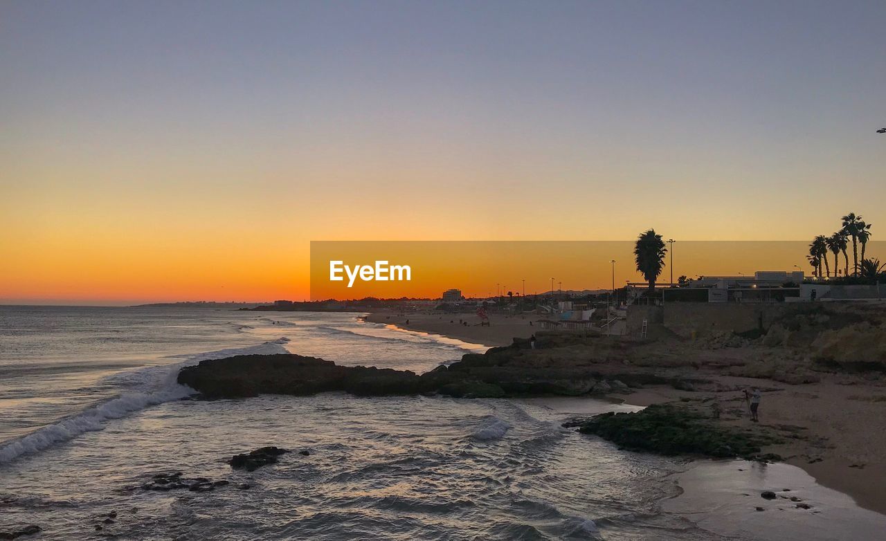 Scenic view of sea against clear sky during sunset