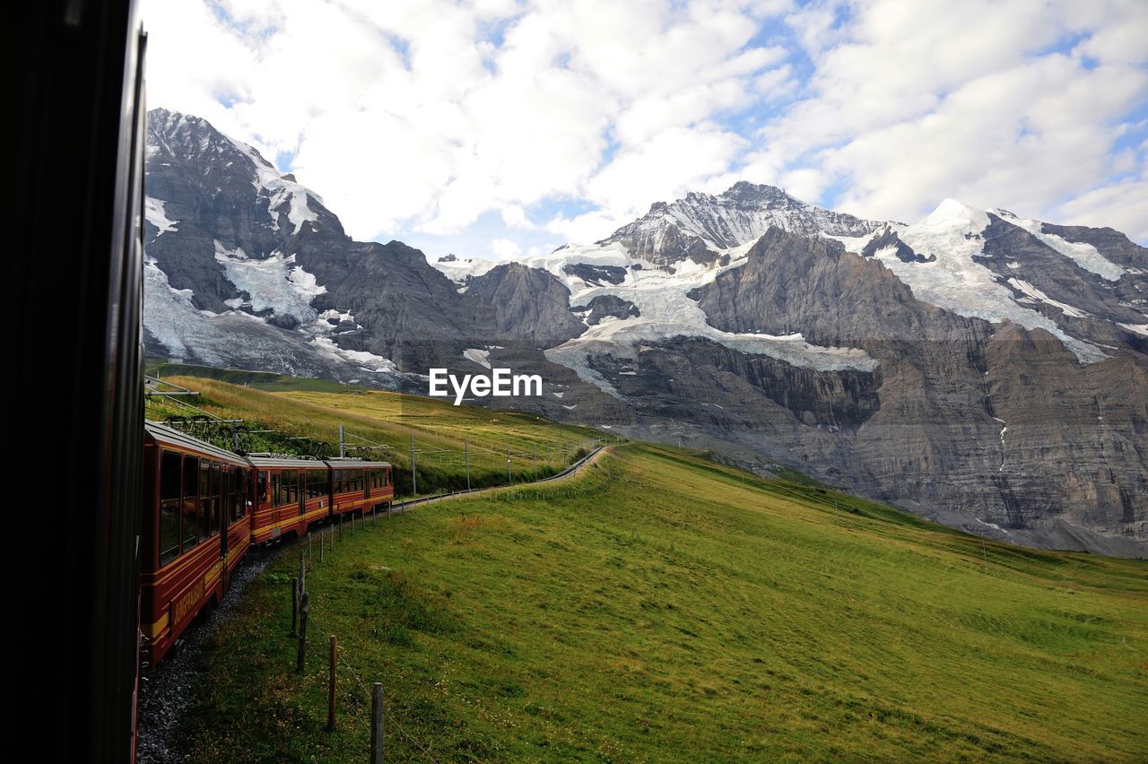 Train towards snowcapped mountain