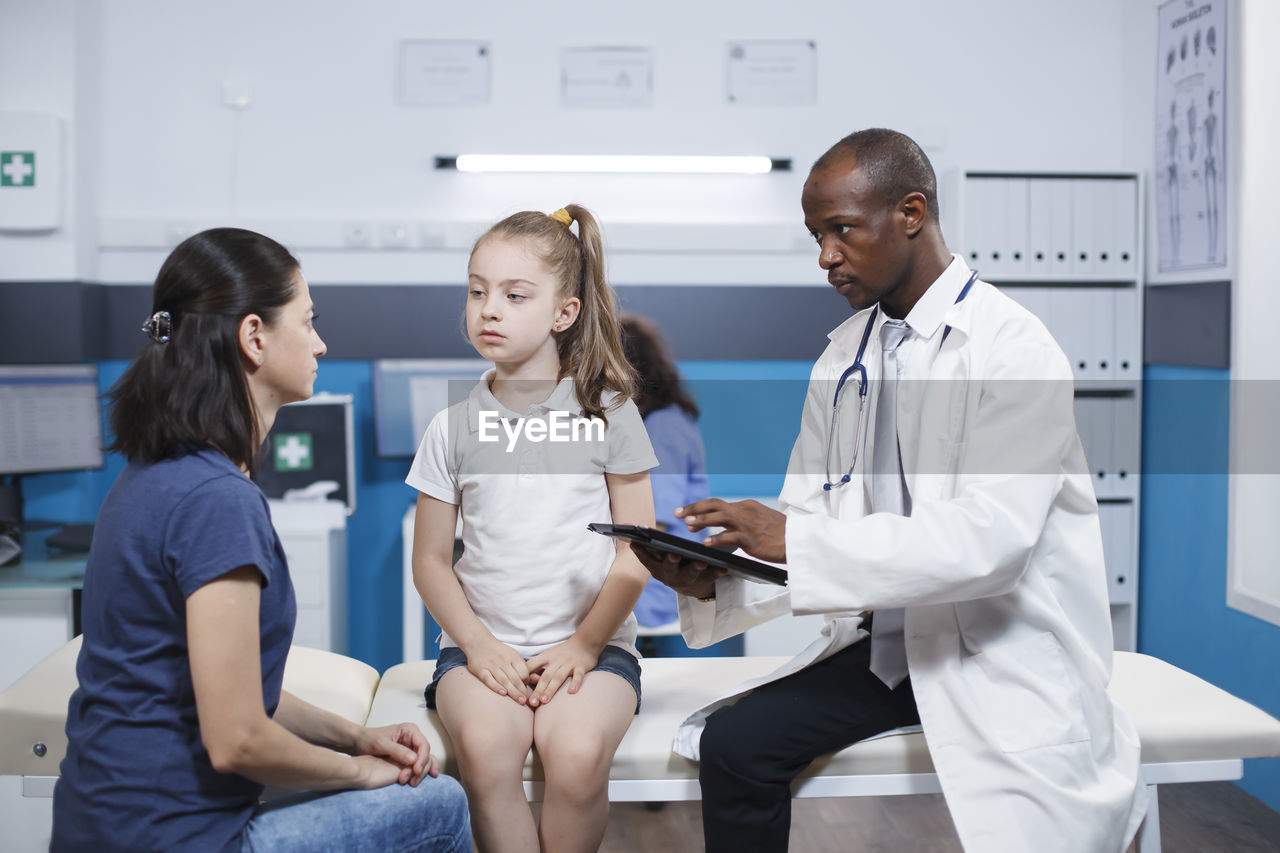 female doctor explaining to patient in clinic