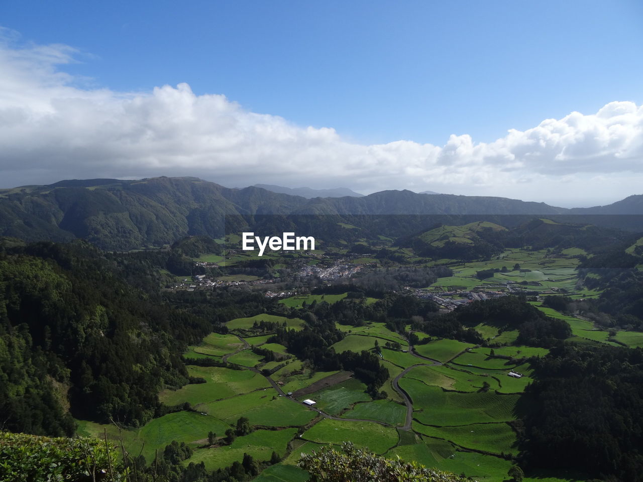 Scenic view of field and mountains against sky