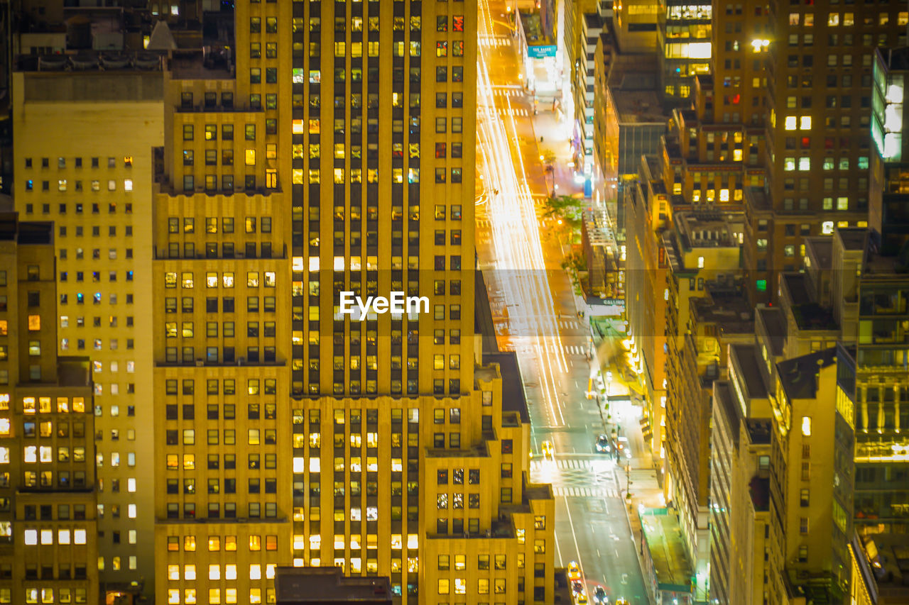 VIEW OF ILLUMINATED CITY STREET AT NIGHT