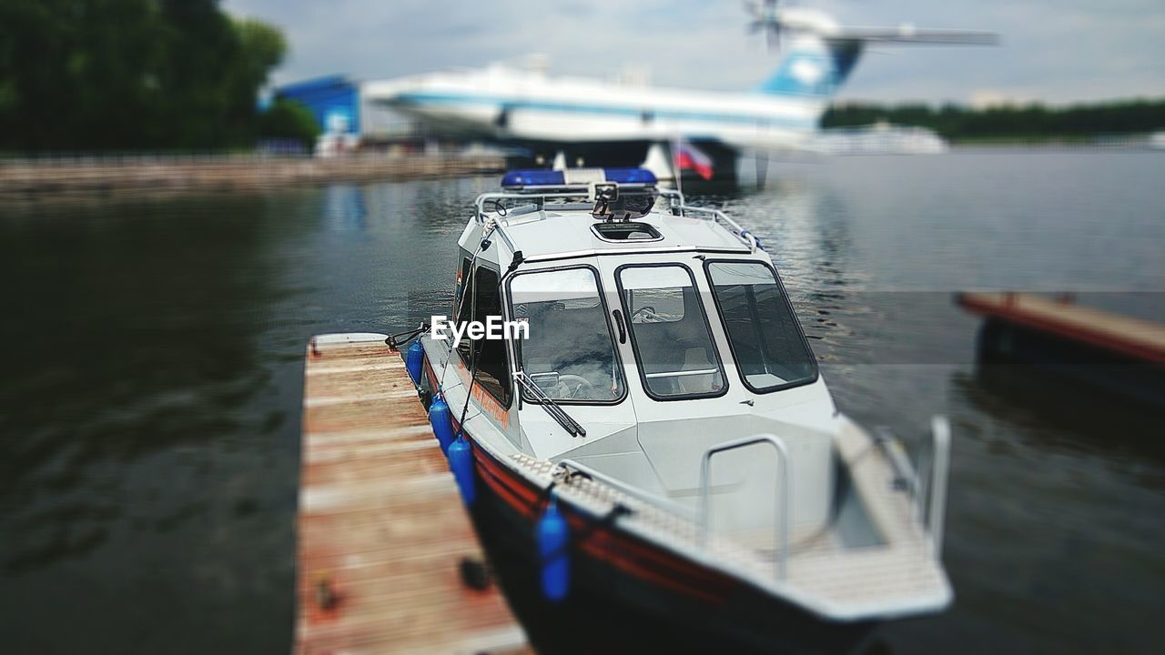 CLOSE-UP OF BOAT SAILING ON LAKE