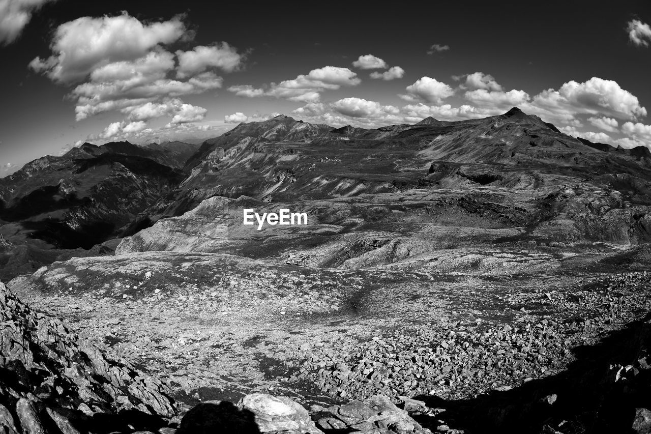 mountain, environment, scenics - nature, landscape, black and white, sky, cloud, beauty in nature, mountain range, monochrome, rock, monochrome photography, nature, no people, tranquility, travel destinations, non-urban scene, travel, land, tranquil scene, snow, outdoors, extreme terrain, mountain peak, day, cold temperature, geology, physical geography, water, tourism, snowcapped mountain, winter