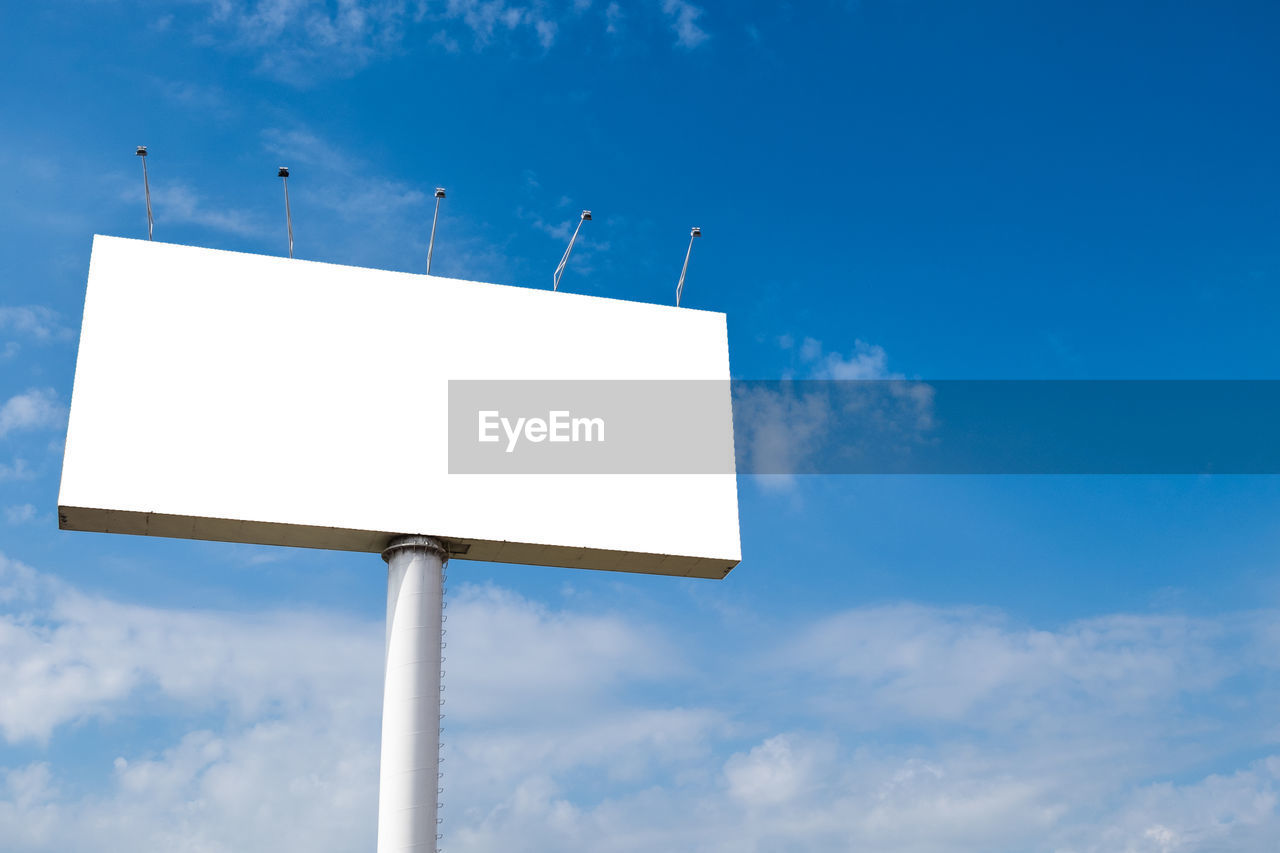 Large billboards with a cloudy sky background