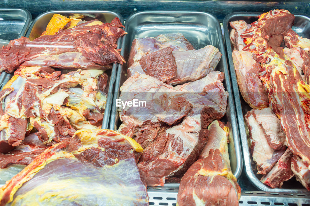 food, food and drink, freshness, dish, meat, for sale, high angle view, still life, no people, retail, raw food, meal, cuisine, abundance, variation, market, large group of objects, indoors, business finance and industry, lamb and mutton, container, business, healthy eating, close-up, wellbeing