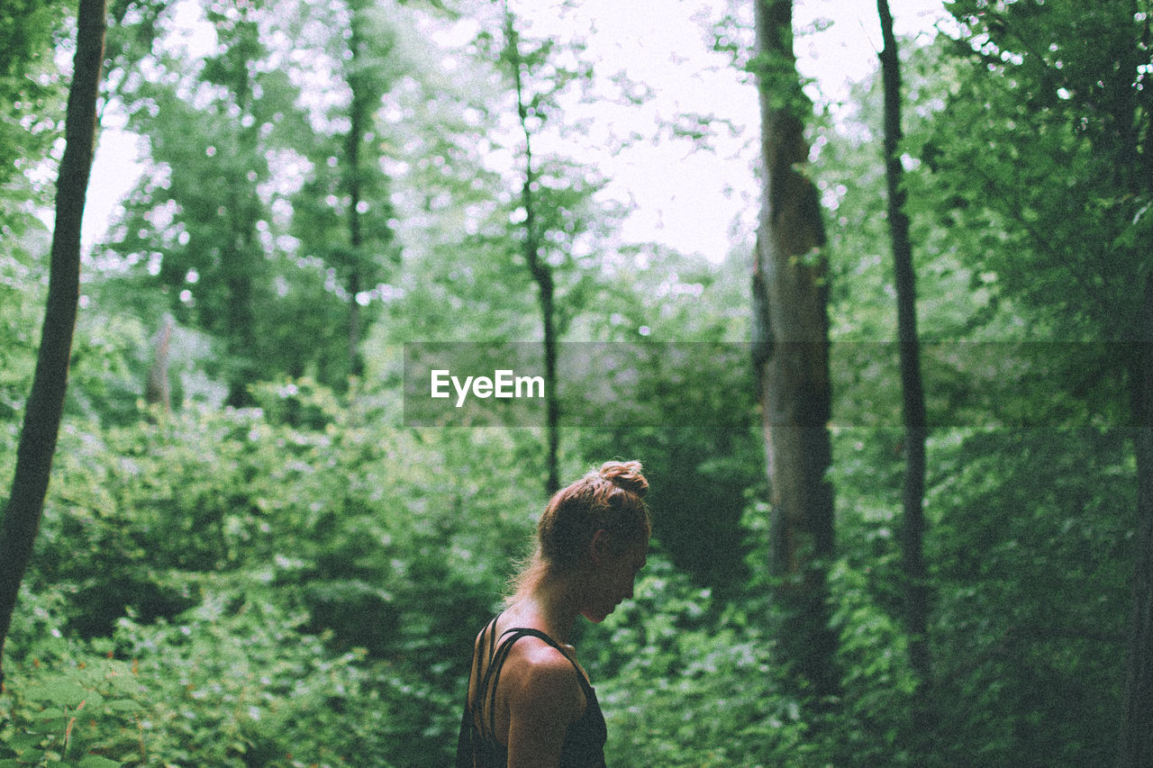 Low section of woman in forest