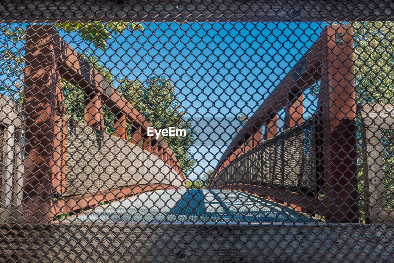 Footbridge seen through chainlink fence
