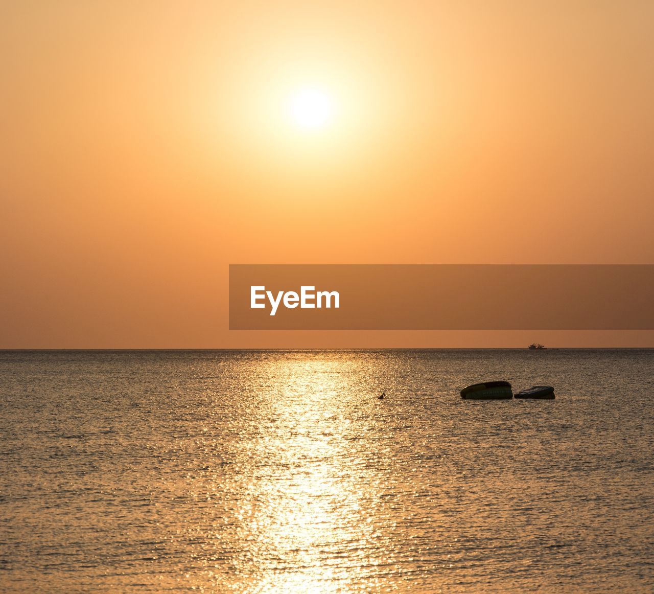 SCENIC VIEW OF SEA AGAINST ORANGE SKY DURING SUNSET