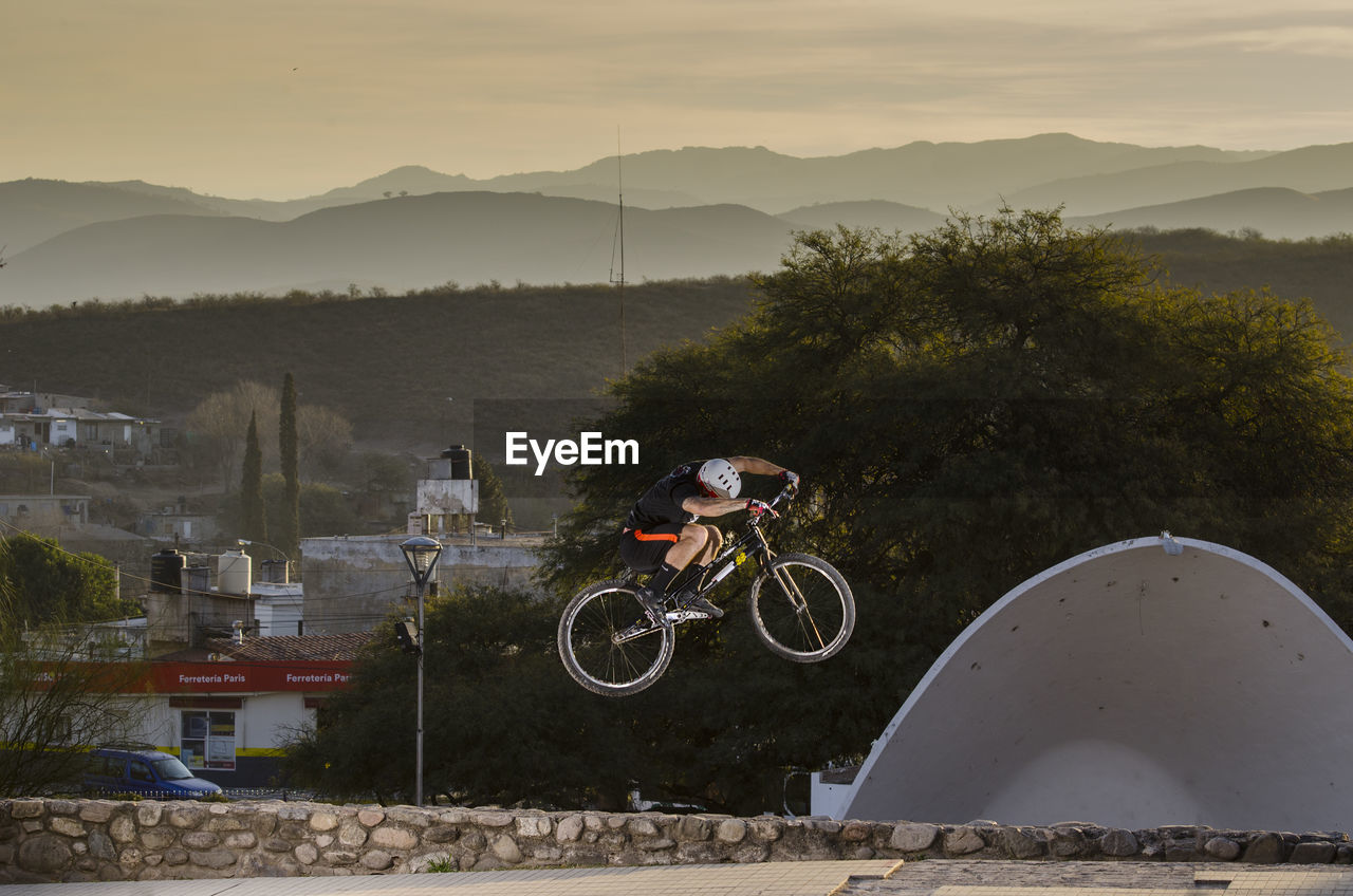 MAN RIDING BICYCLE ON MOUNTAIN