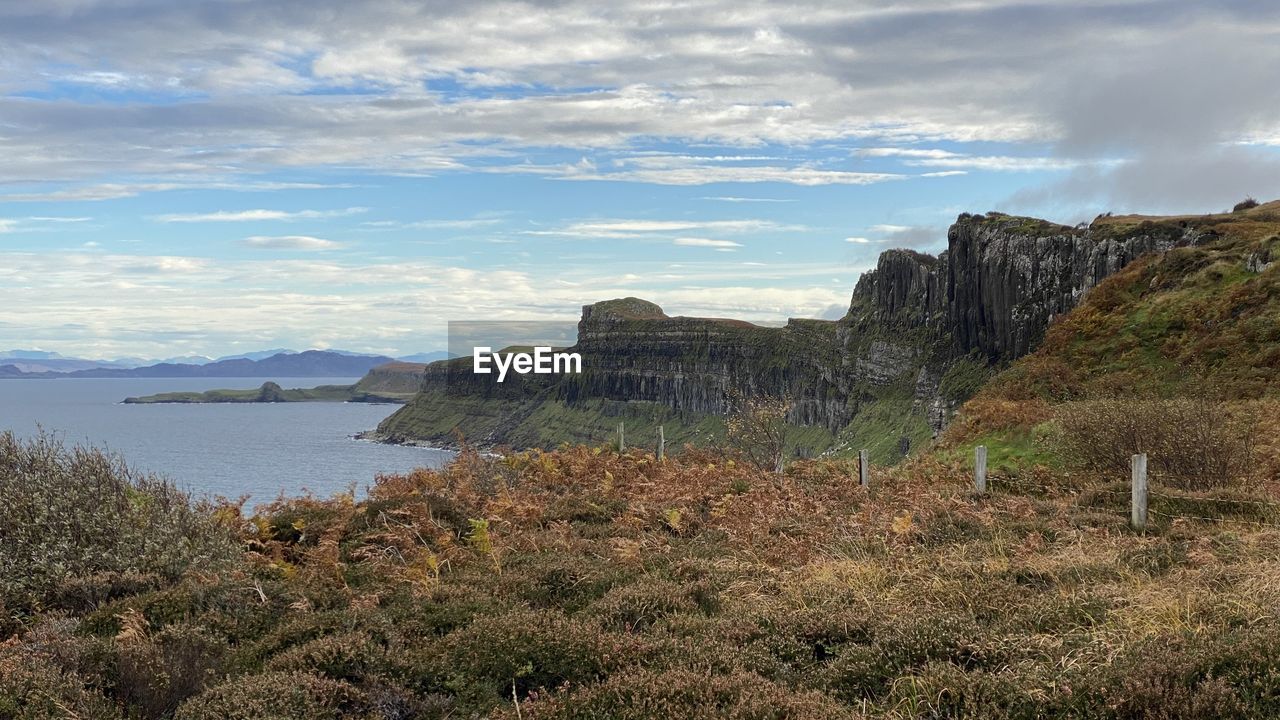 sky, rock, cloud, water, scenics - nature, mountain, landscape, cliff, nature, land, sea, coast, environment, beauty in nature, travel destinations, travel, plant, no people, beach, wilderness, terrain, tranquility, tourism, tranquil scene, outdoors, non-urban scene, architecture, rock formation, coastline, tree, shore, day, geology