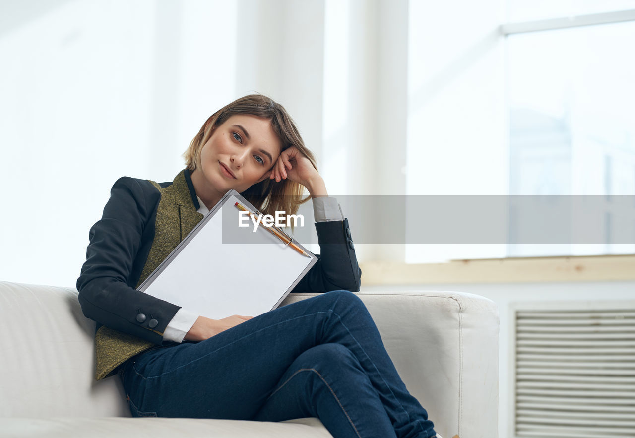 Portrait of businesswoman sitting of sofa