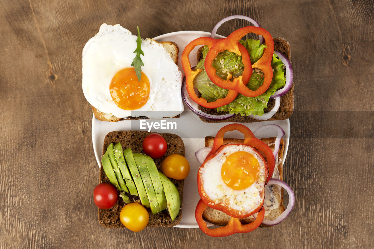 Healthy breakfast with various of sandwiches and toasts on the white plate. top view.