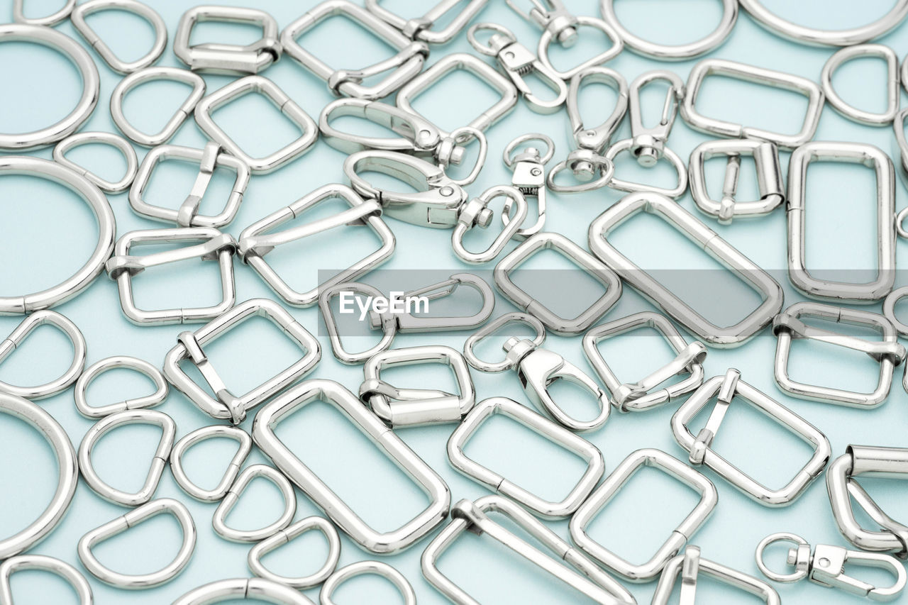 backgrounds, font, no people, large group of objects, metal, full frame, chain, pattern, clip, indoors, paper clip, aqua, studio shot, close-up, repetition, abundance, silver