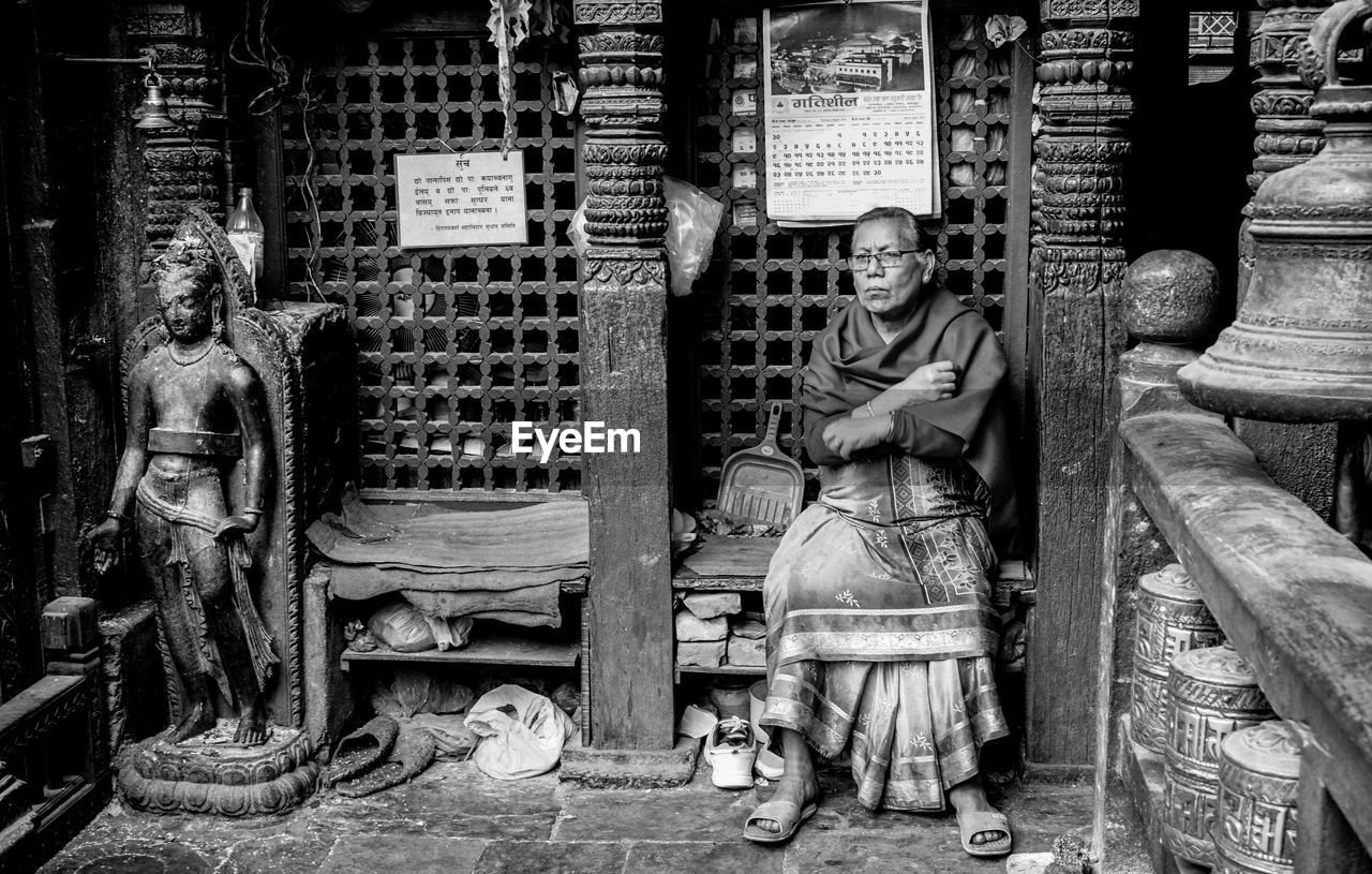 Senior woman sitting in temple