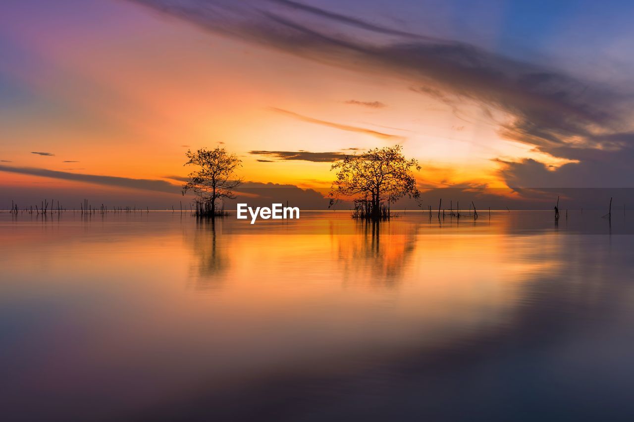 Scenic view of lake against orange sky