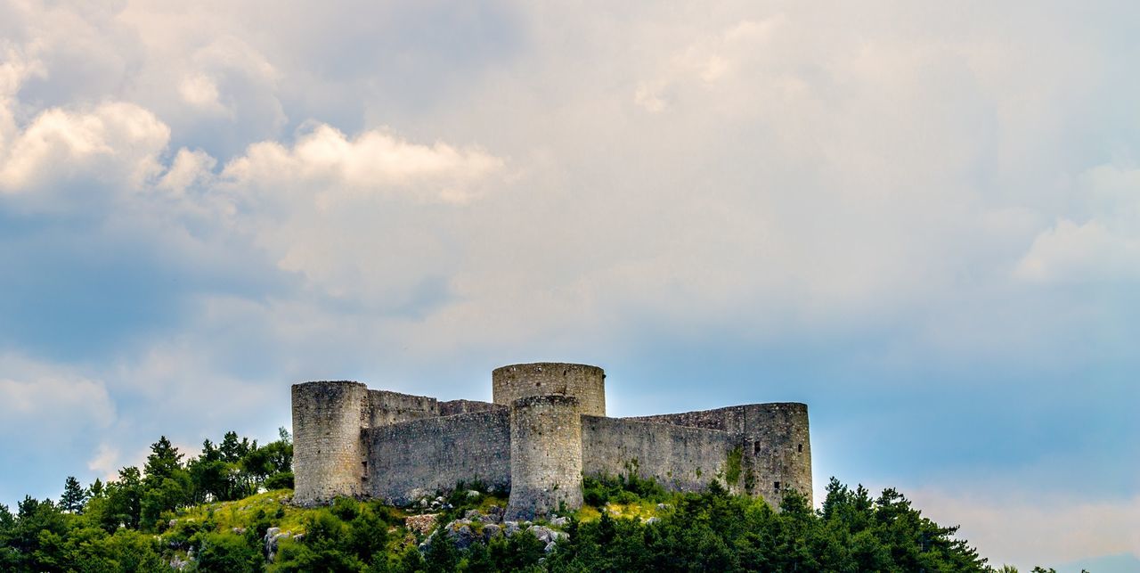 LOW ANGLE VIEW OF OLD RUIN BUILDING AGAINST CLOUDY SKY