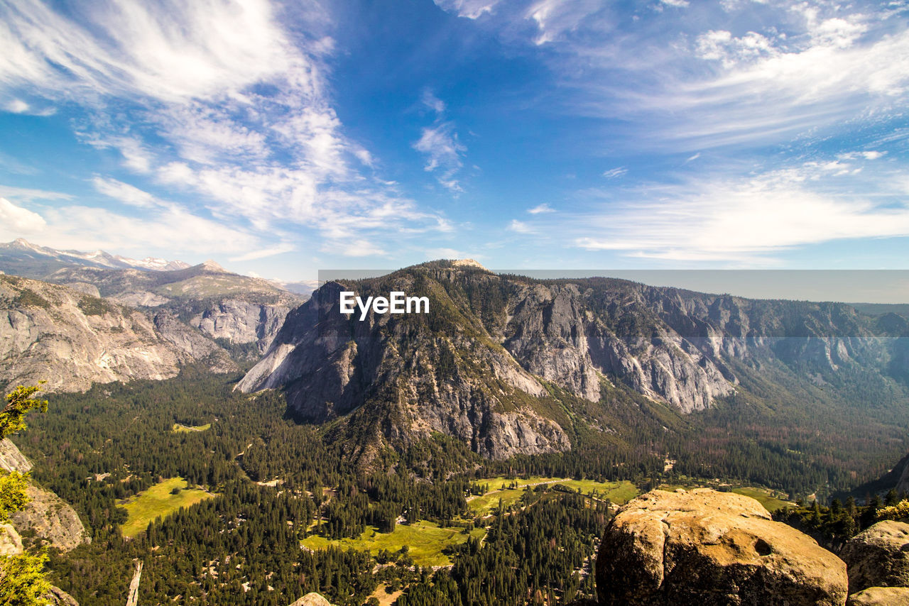 Scenic view of mountains against cloudy sky