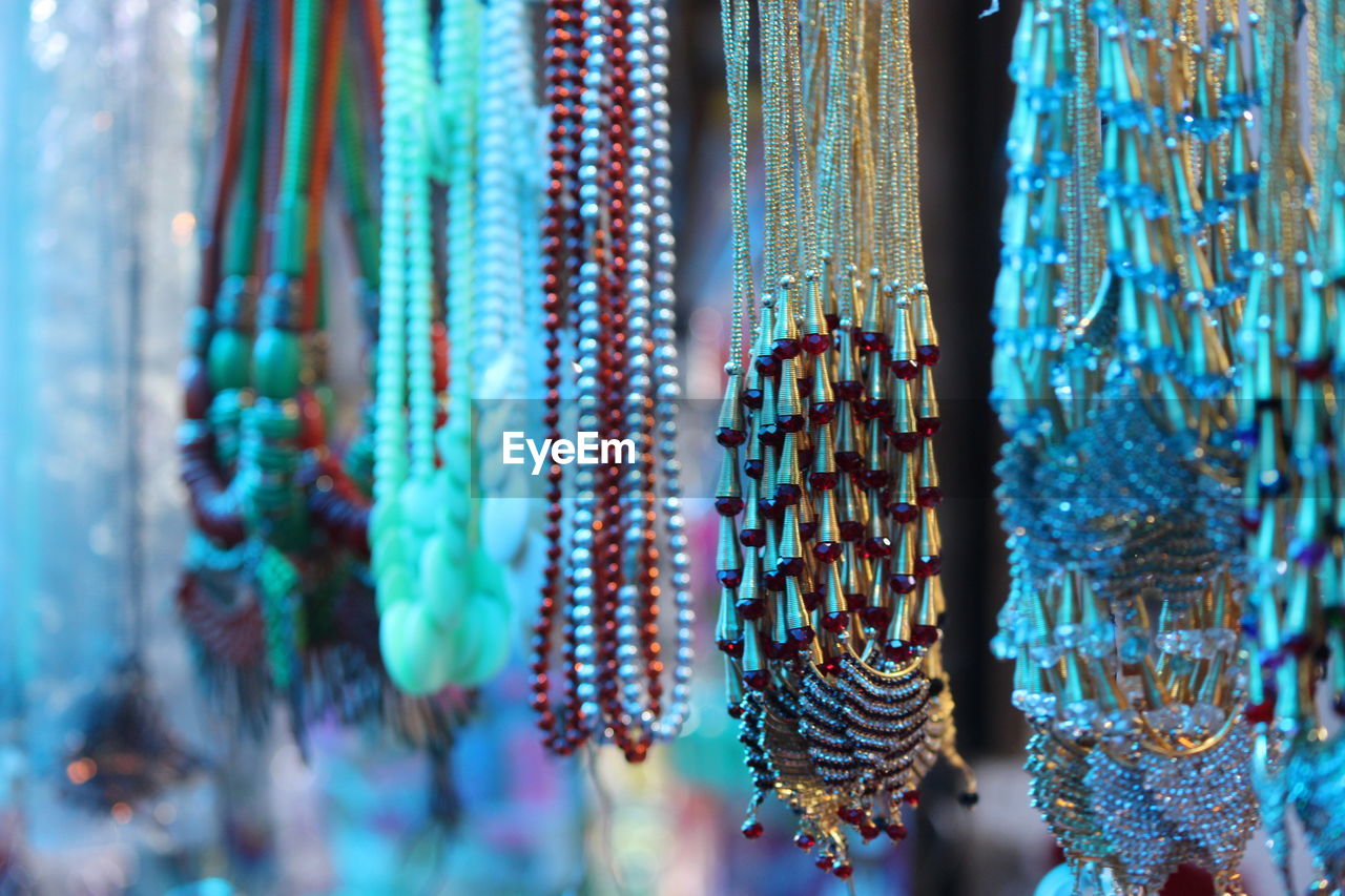 Low angle view of jewelry hanging at market stall