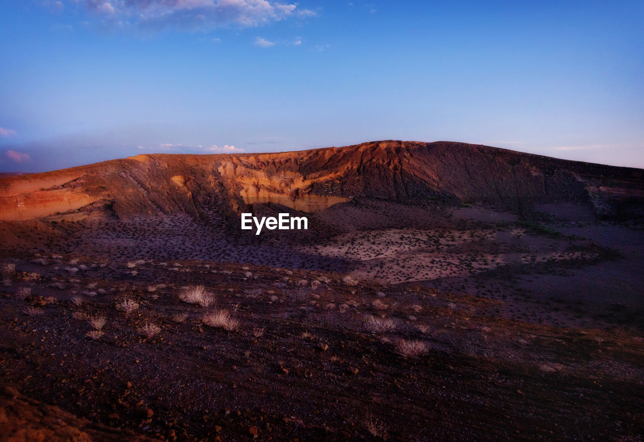 View of desert against cloudy sky