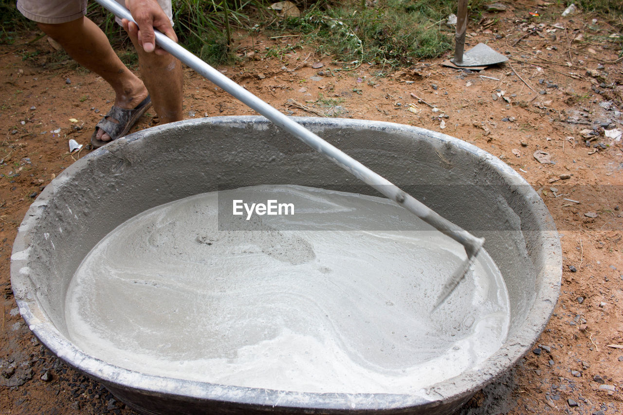 HIGH ANGLE VIEW OF MAN WORKING ON SHORE