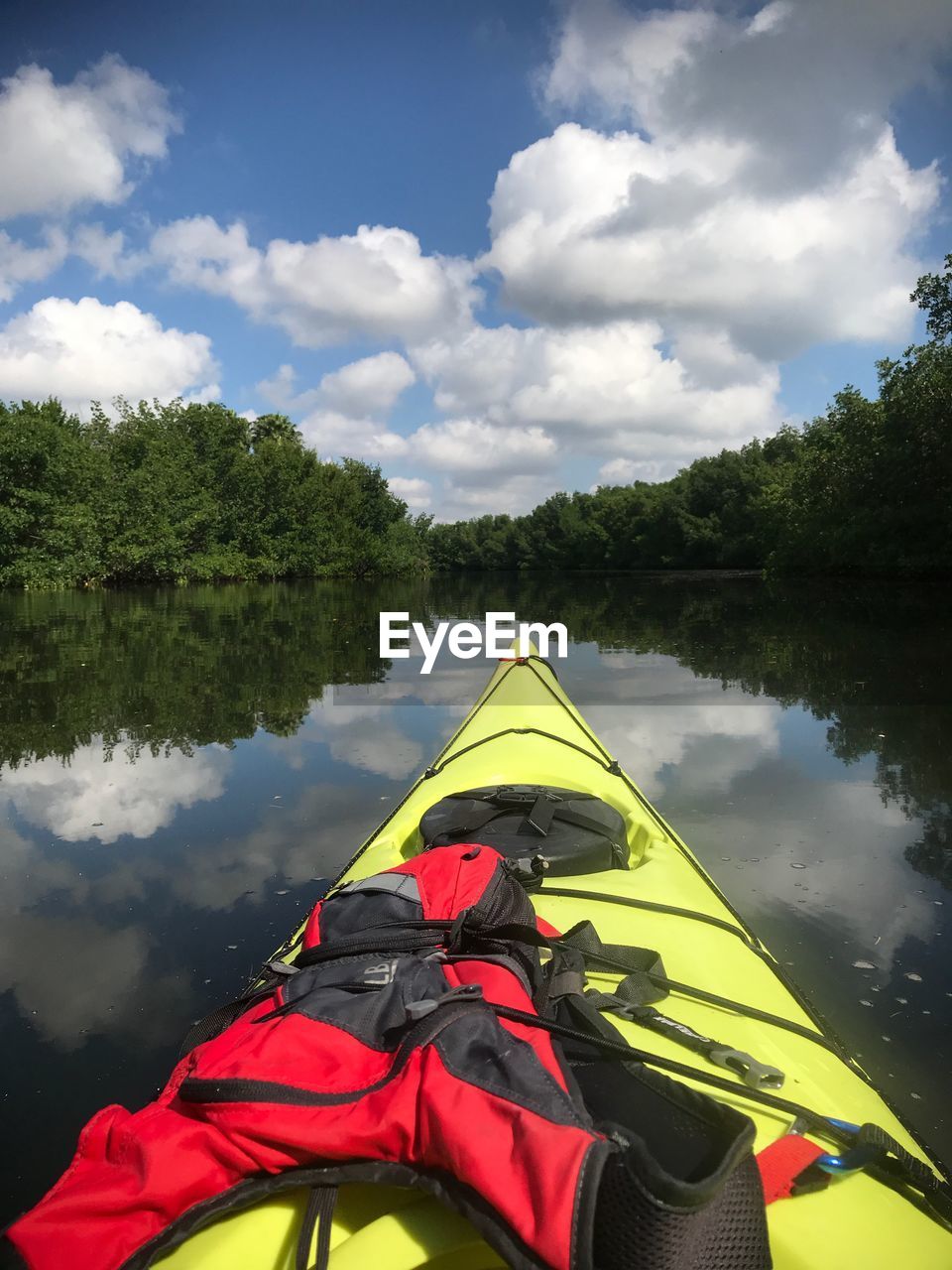 PERSON FLOATING ON LAKE AGAINST SKY