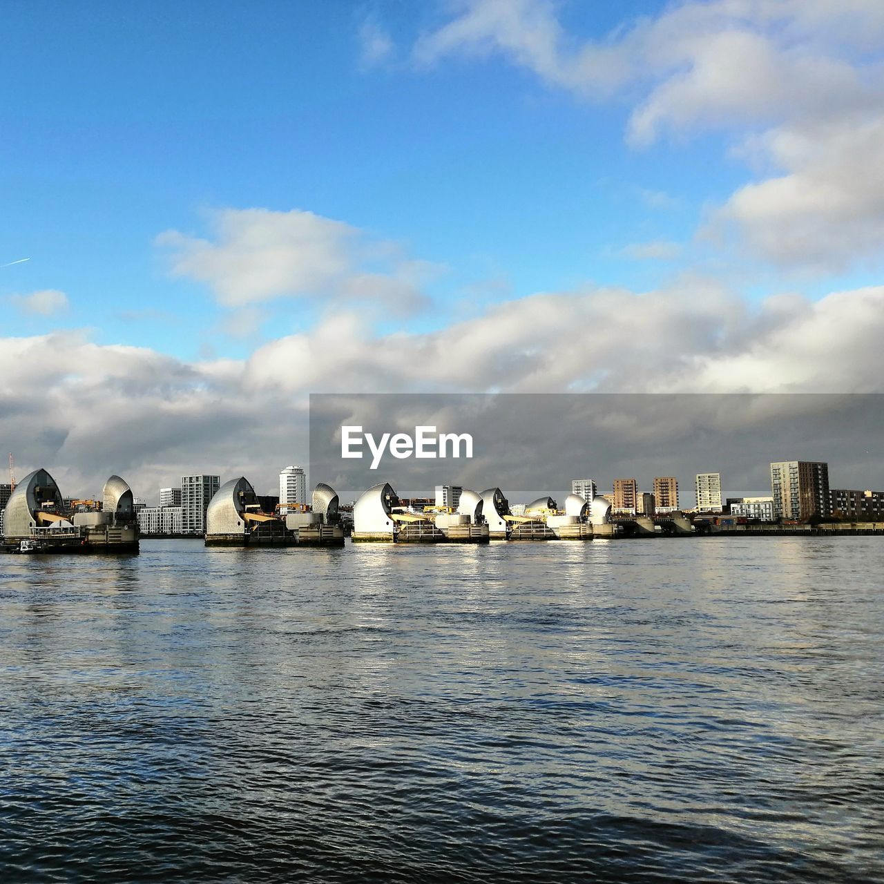 SCENIC VIEW OF SEA AGAINST BUILDINGS IN CITY