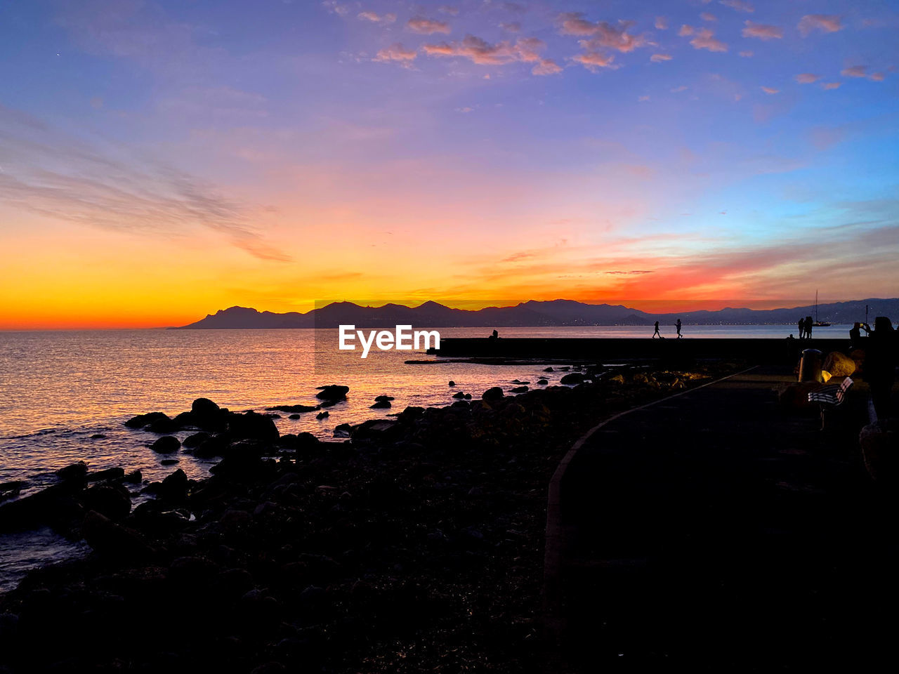 SCENIC VIEW OF SUNSET OVER SEA