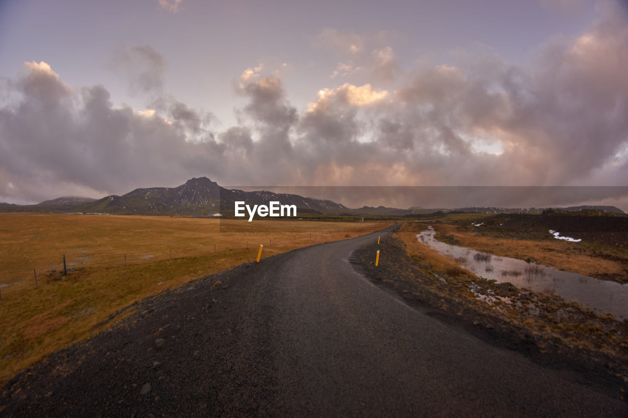 Empty road along countryside landscape