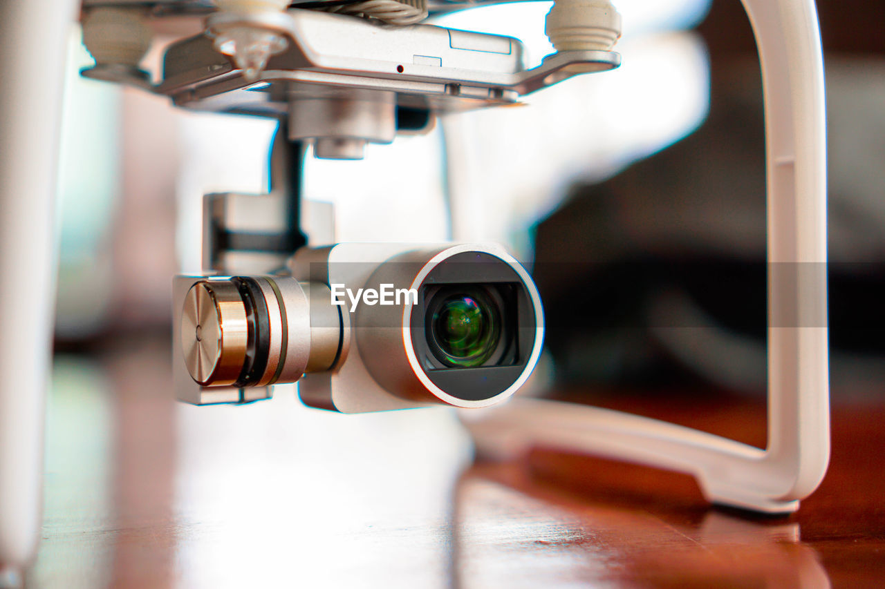 CLOSE-UP OF CAMERA ON TABLE WITH EYEGLASSES