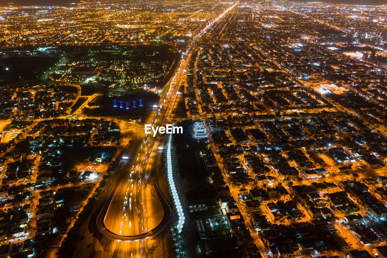 HIGH ANGLE VIEW OF ILLUMINATED CITYSCAPE AT NIGHT