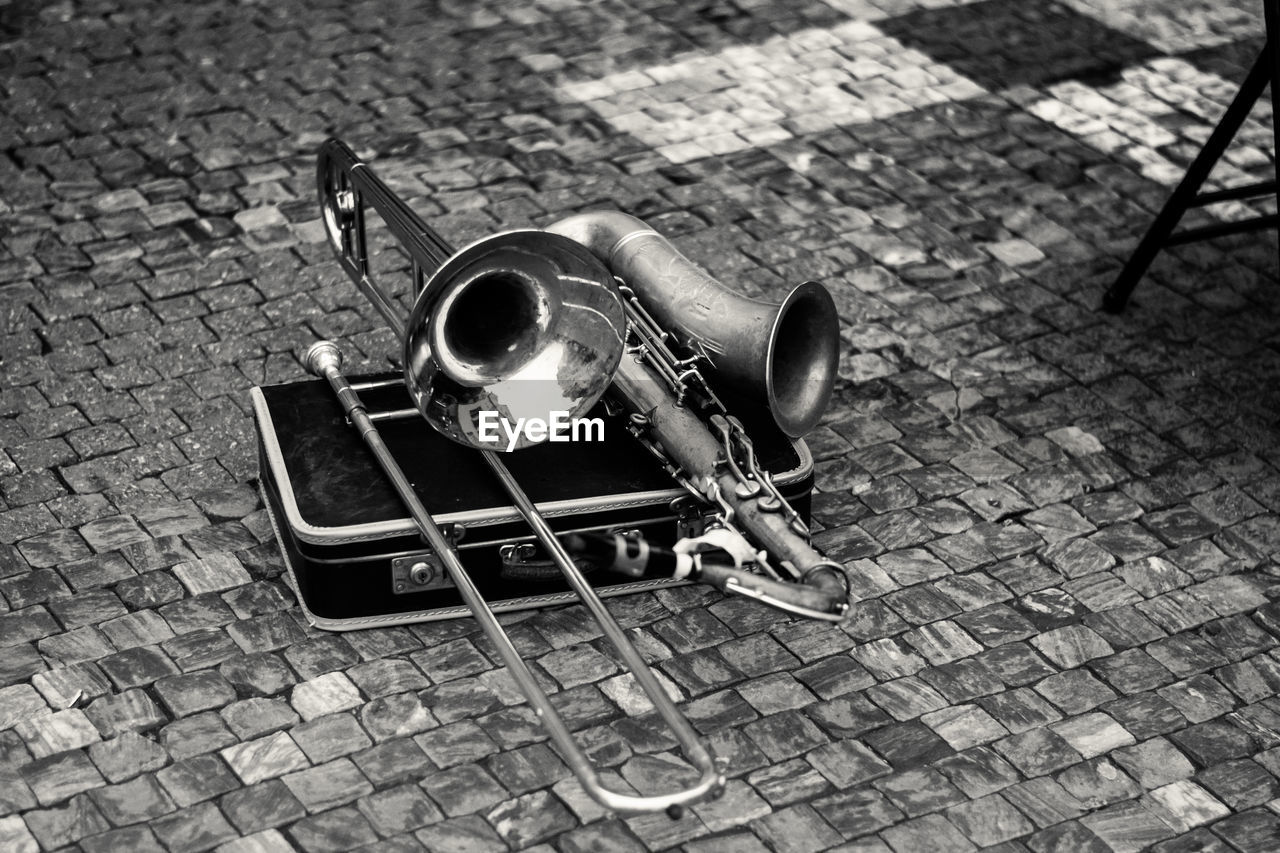 High angle view of musical instruments on cobblestone street