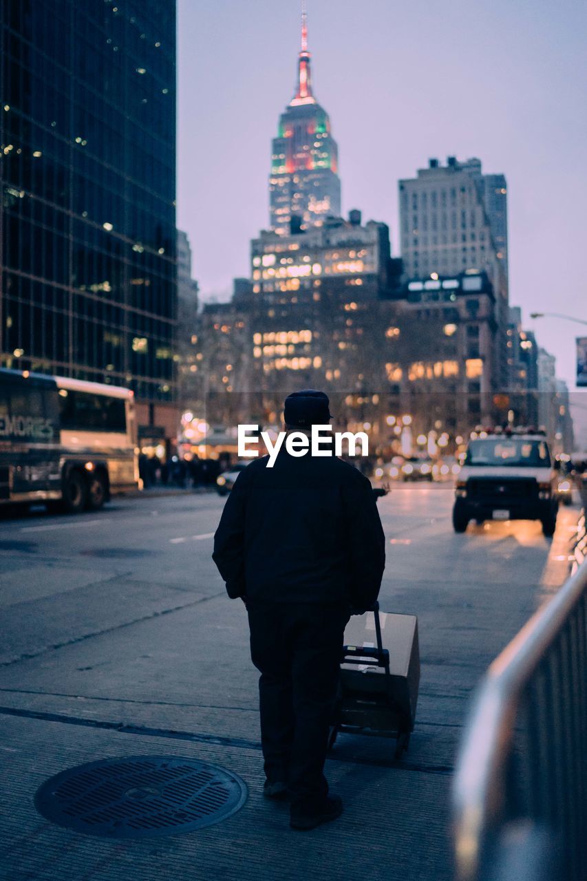 Rear view of man with cityscape in background