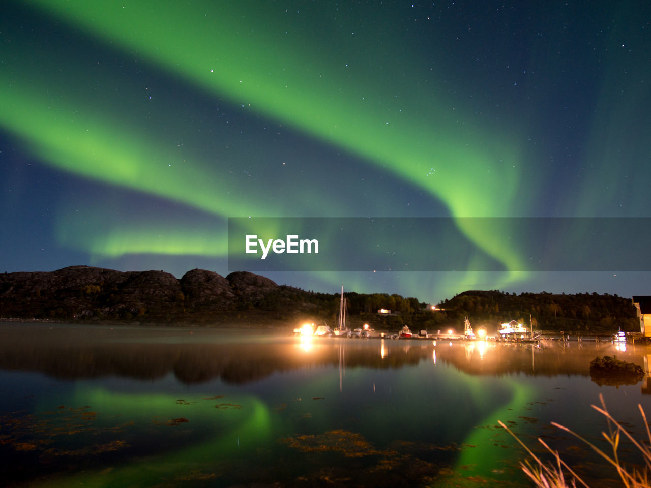 Scenic view of illuminated landscape against sky at night