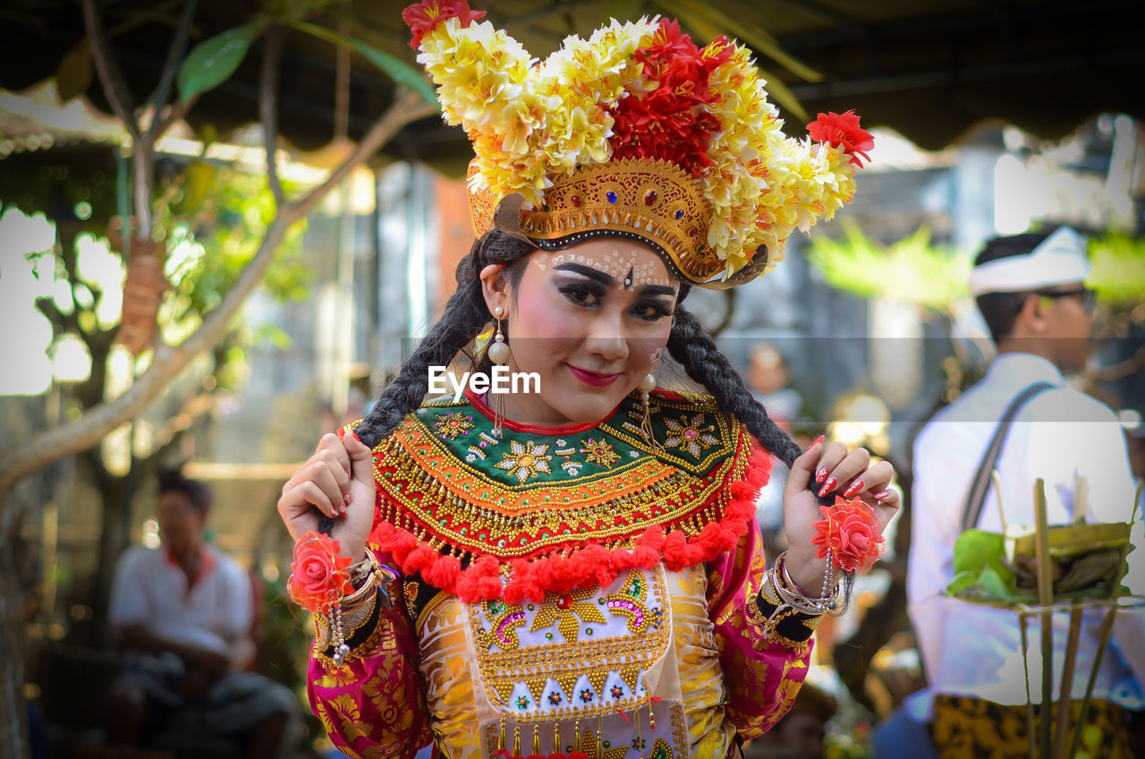 Portrait of woman wearing traditional clothing with make-up and flowers