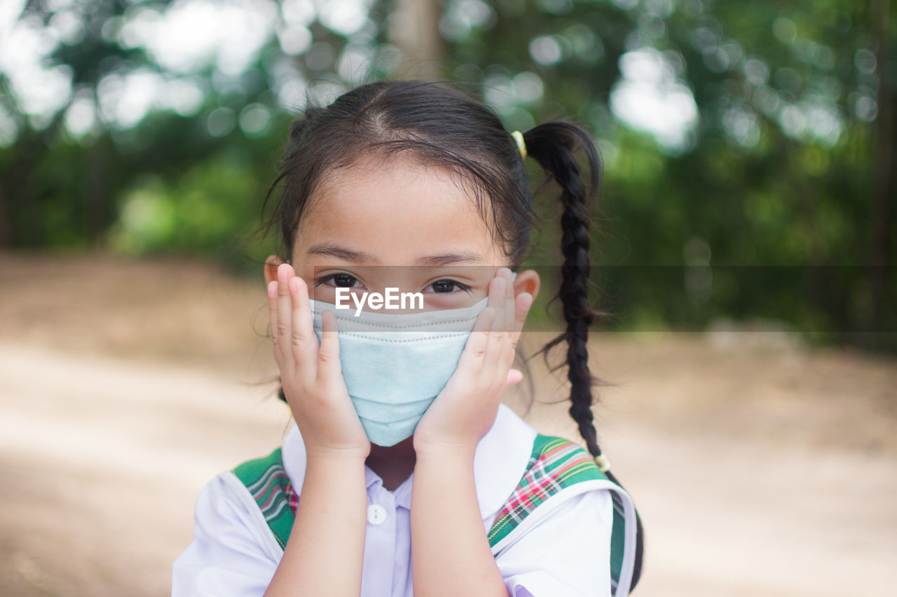 Portrait of girl wearing mask outdoors