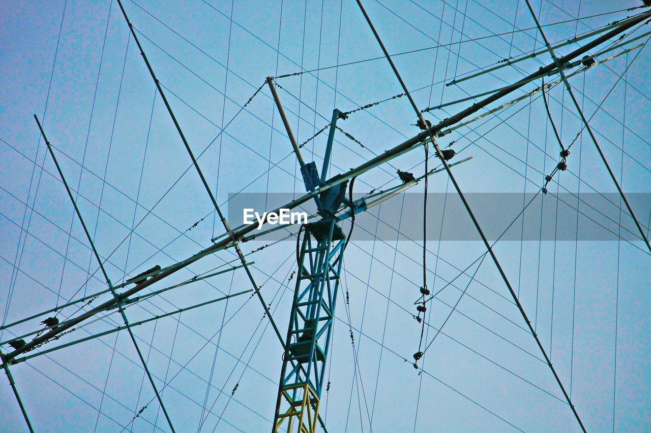 Low angle view of mast against blue sky