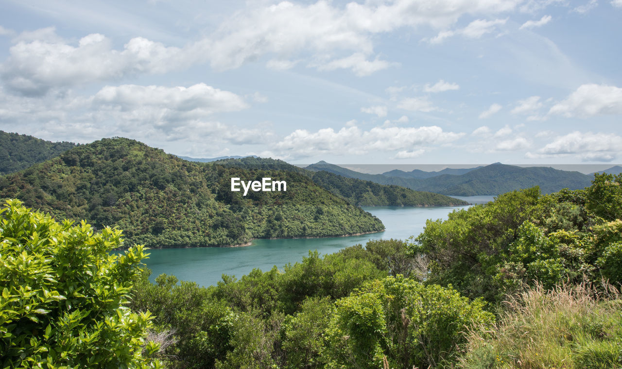 Scenic view of lake and mountains against sky