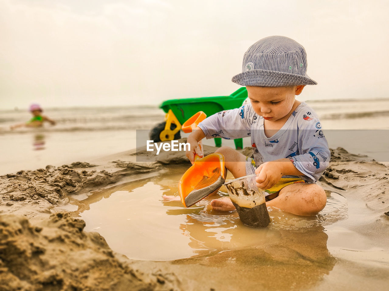 Boy holding umbrella on beach