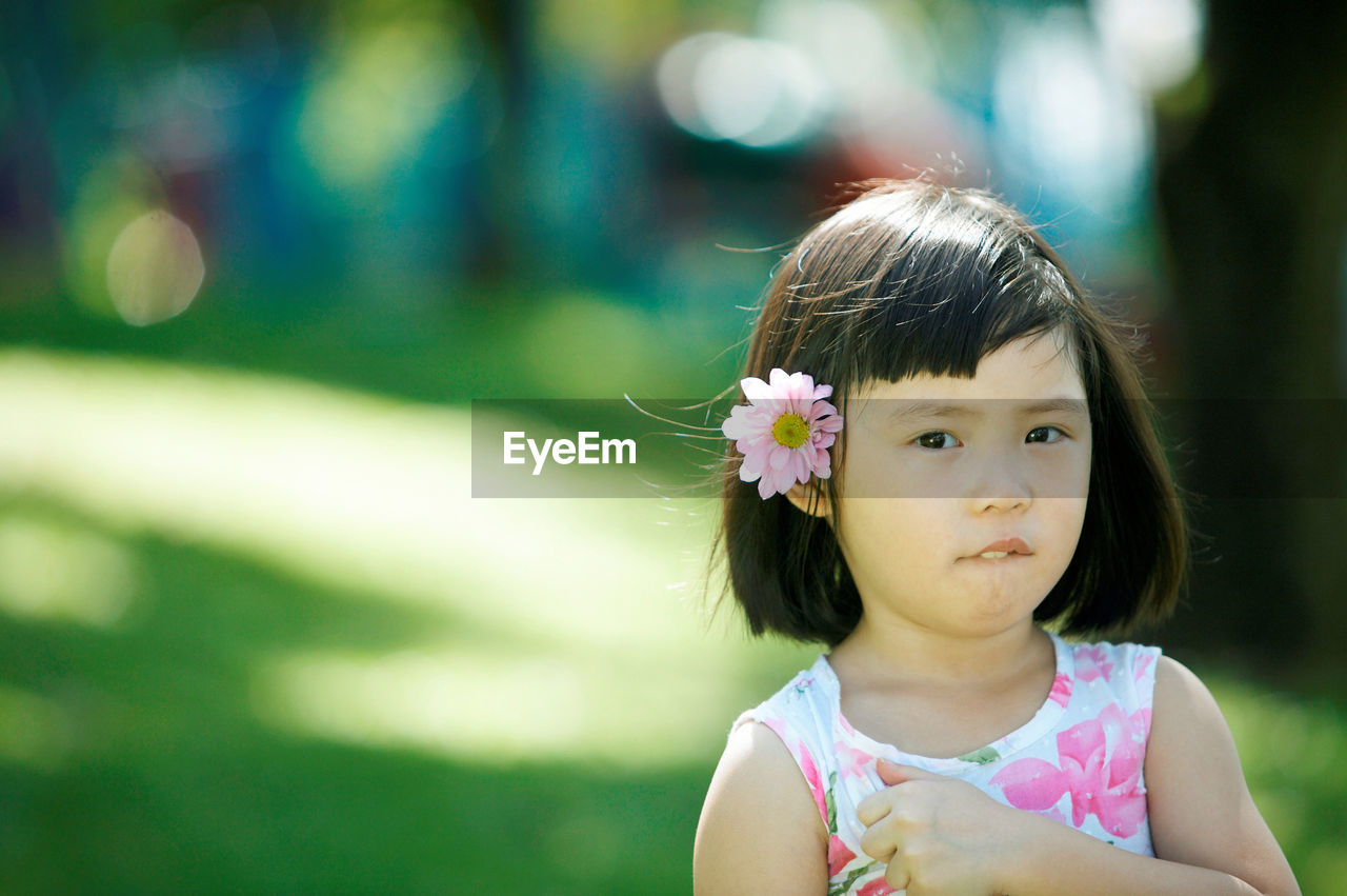 Close-up portrait of girl standing at park