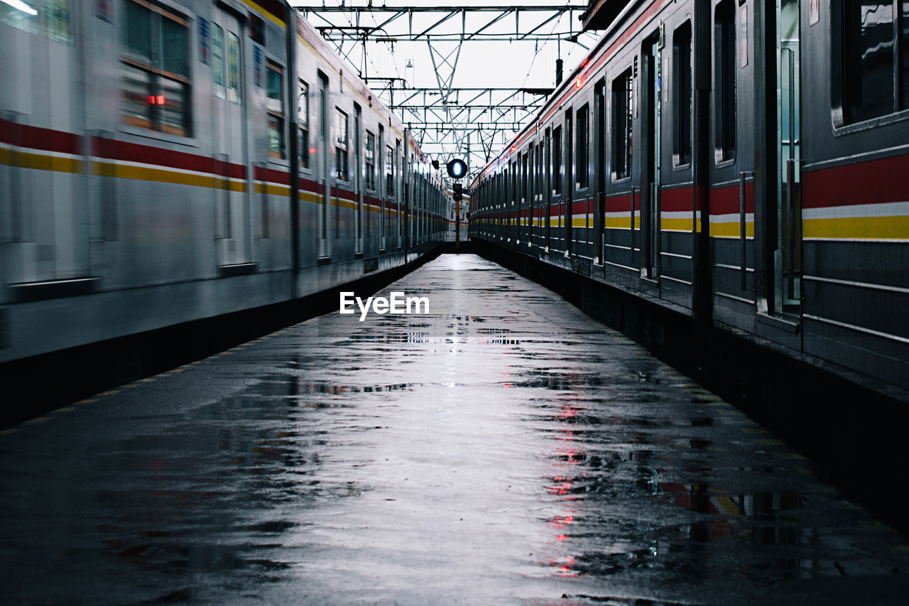 Trains at railroad station during rainy season