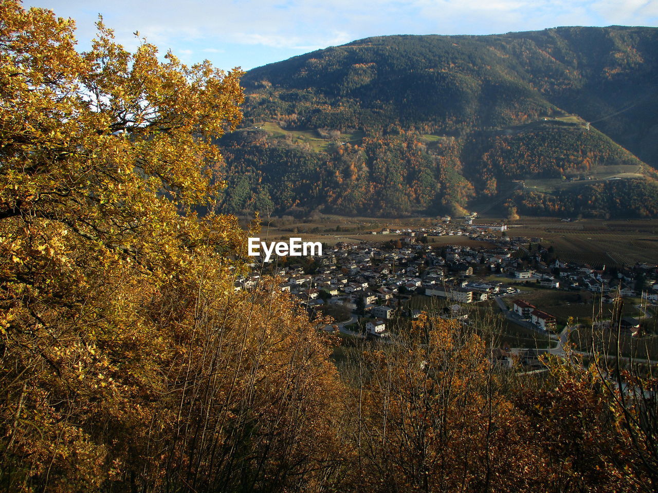 autumn, nature, environment, landscape, mountain, plant, tree, scenics - nature, land, leaf, beauty in nature, sky, morning, no people, mountain range, outdoors, travel destinations, architecture, tranquility, travel, cloud, wilderness, day, water, rural area, tranquil scene, city, building, forest, tourism, high angle view, rural scene, building exterior