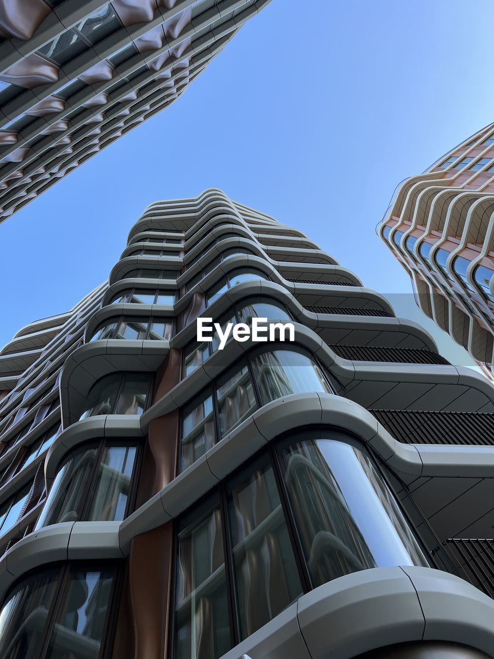 architecture, built structure, skyscraper, building exterior, city, office building exterior, building, sky, low angle view, no people, office, clear sky, blue, business, day, futuristic, metropolis, pattern, outdoors, nature, facade