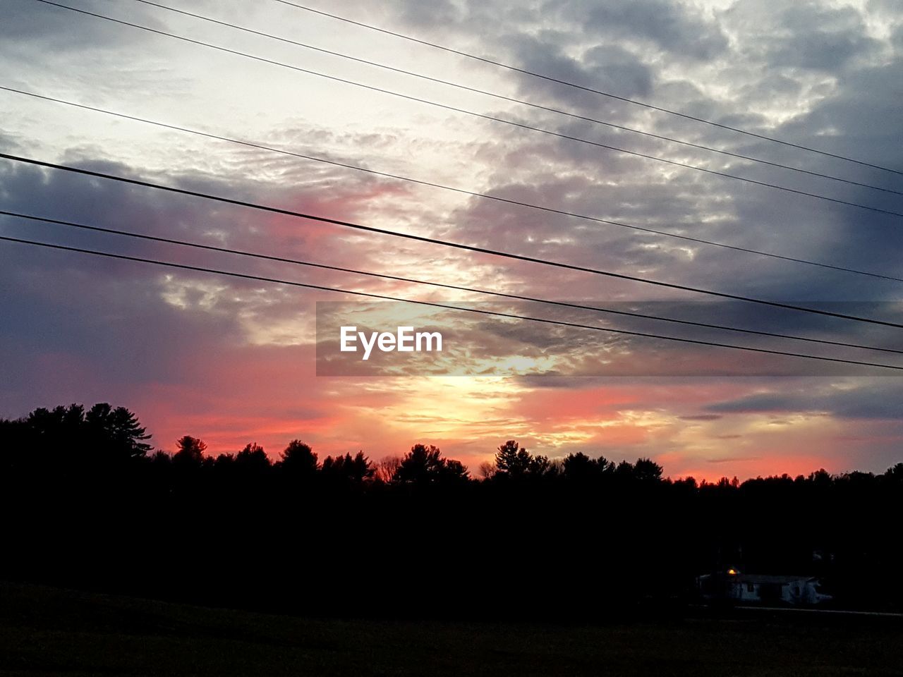 SILHOUETTE TREES AND ELECTRICITY PYLON AGAINST SKY AT SUNSET