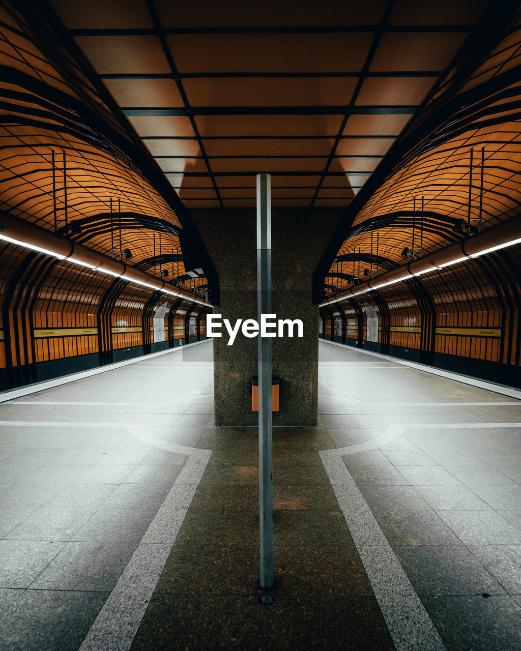 Empty illuminated railroad station platform