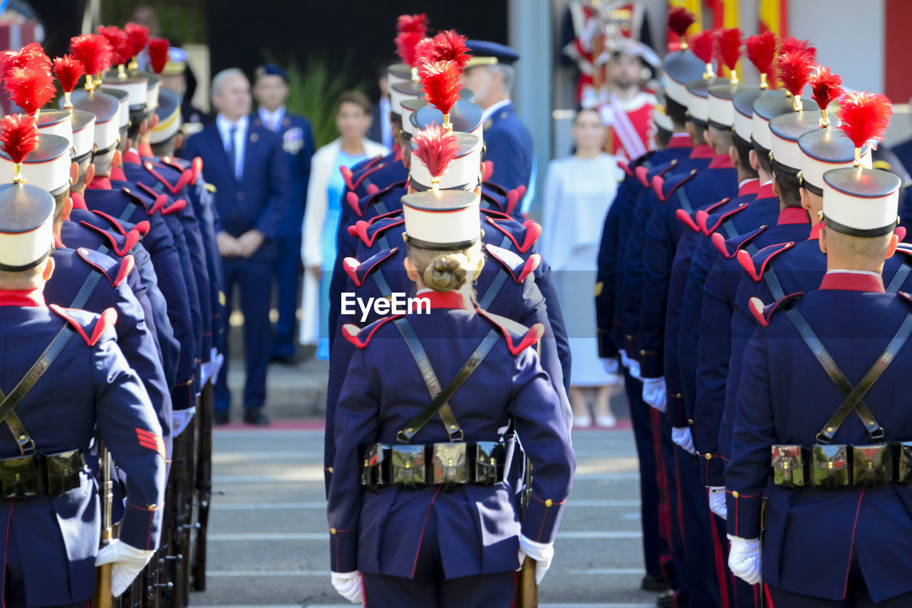 clothing, group of people, marching, uniform, celebration, military, event, tradition, person, government, in a row, day, military uniform, crowd, armed forces, parade, men, outdoors, festival, headwear, adult, traditional clothing, large group of people, hat, arts culture and entertainment