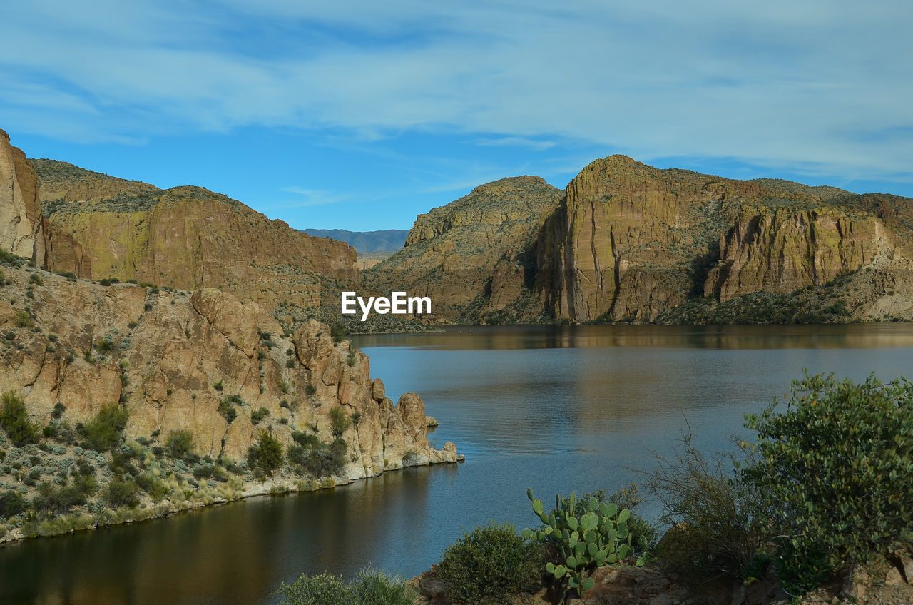 Scenic view of lake and mountains against sky